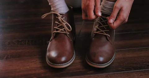 Young man put on shoes Video stock 135056379