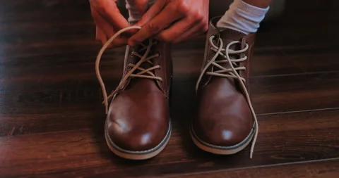 Young man put on shoes Stock Footage 135056722
