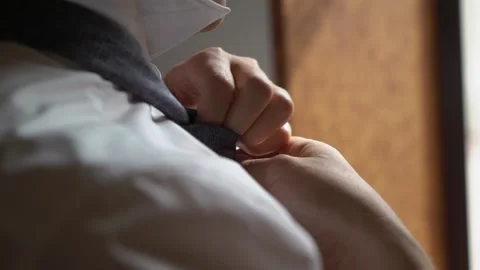 Young man put on tie Stock Footage 150527924