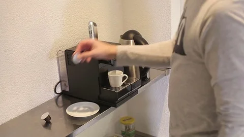 The young man puts capsule coffee in the coffee machine. Stock Footage 71777629