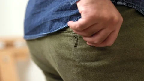 A young man puts a condom in his pants pocket to prepare for use. Campaign for s Stock Footage 161234724