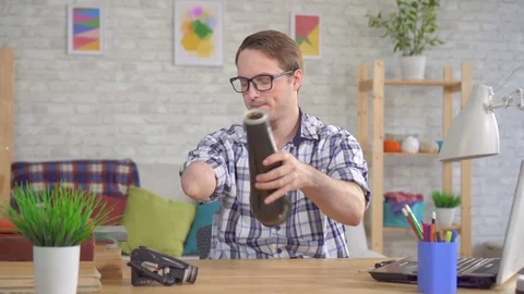 Young man puts a cyber prosthesis on his hand Stock Footage 119275370