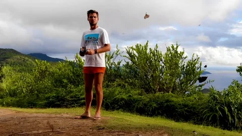 A young man puts a drone on the ground. Stock Footage 102027546