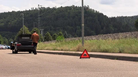 A young man puts an emergency sign Stock Footage 114200165
