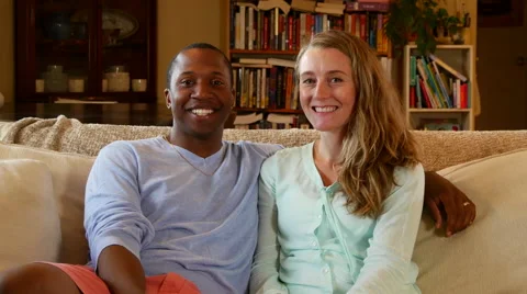 Young man puts his arm around his wife, smiles at camera Stock Footage 53013793