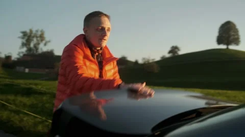 A young man puts his backpack in the car boot preparing for vacation Video stock 201165051