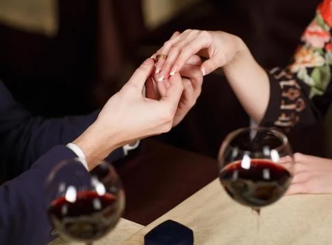 Young Man puts the ring on the finger of his girlfriend Stock Photos