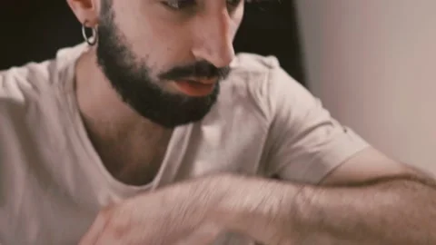 Young man puts some marijuana on a cookie and crumbles it into tea Stock-Footage 197813441