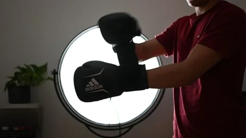 Young man putting on boxing gloves Stock Footage 260229449