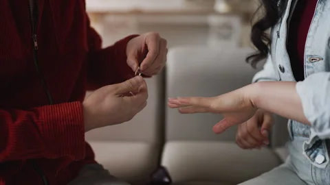 Young man putting engagement ring on girlfriend's finger, marriage proposal Stock Footage 327865959