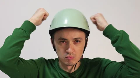 Young man putting on a protective bicycle helmet Video stock 344058225