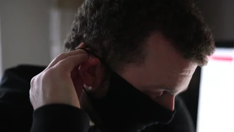 Young Man Putting on a Protective Mask to Protect Against Coronavirus Stock Footage 148144718