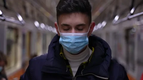 Young man putting on protective mask in metro Video stock 149622222
