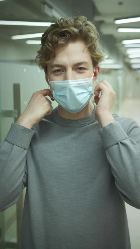 A young man is putting off a protective mask Stock Footage 160134482