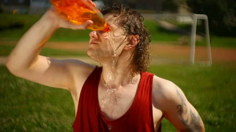 Young man quenches thirst after sports Stock Footage