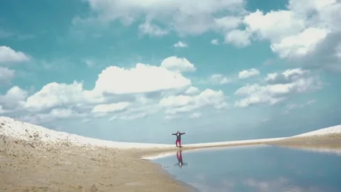 Young man raises his hands near river Stock Footage 127902986