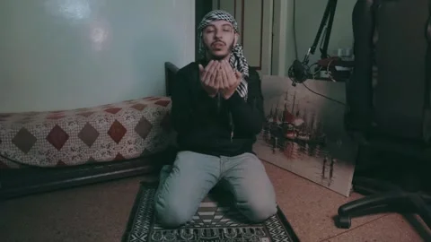 Young man raises his hands to pray to God. Stock Footage 299575996