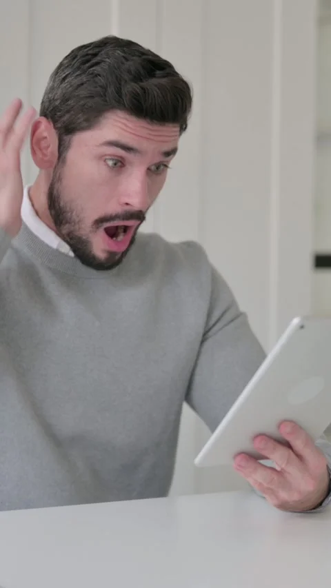 Young Man Reacting to Loss on Tablet while Sitting in Office, Vertical Video Stock Footage 339582230