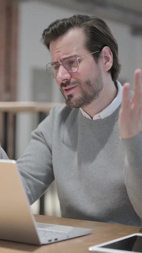 Young Man Reacting to Loss While using Laptop, Vertical Video Stock Footage 339580692