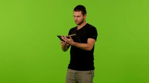 Young man read book greenscreen ms 4K 스톡 동영상 63084601