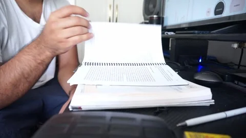 Young Man Reading A Book And Turning Pages, Close Up. Male Hands Holding A Book Video stock 246512228