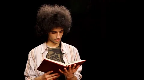 Young man reading a book Stock Footage 3376143