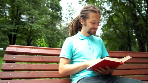 A young man is reading a book Stock Footage 65053156