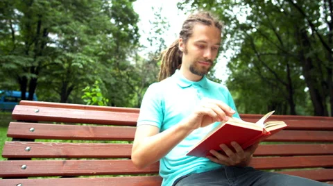 A young man is reading a book Stock Footage 65053623