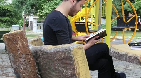 Young man reading book Stock Footage 65373243