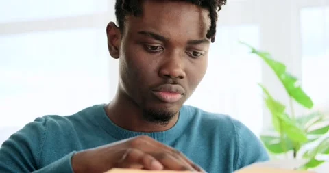 Young man reading a book Stock Footage 156470034