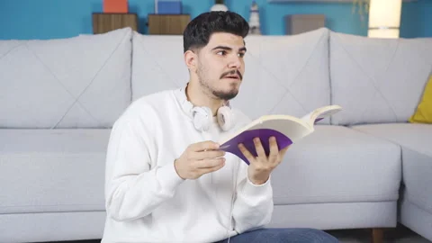 Young man reading a book. Video stock 236206561