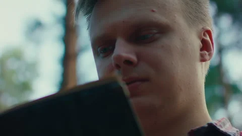 Young Man Reading Book in Forest – Digital Detox Lifestyle Close Up Stock Footage 245797471