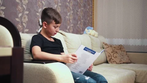 Young man reading book on sofa 動画素材 190023721