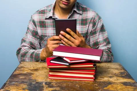 Young man reading on a digital reader Stock Photos