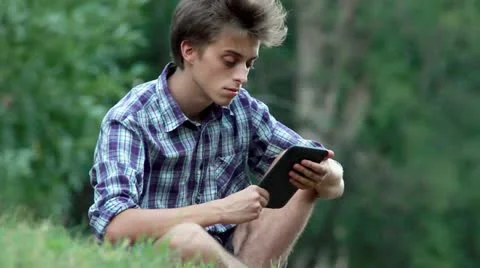 Young man reading e-book Video stock 11594920