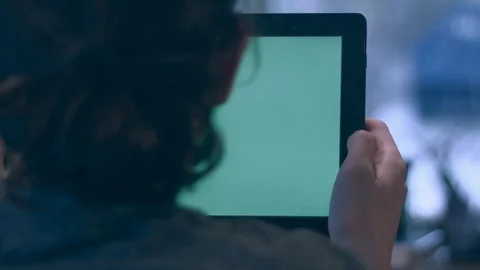 Young man reading on a green screen tablet Stock Footage 75276942