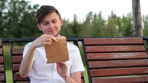 A young man reading a letter. He is happy and having fun reading Stock Footage 79287893