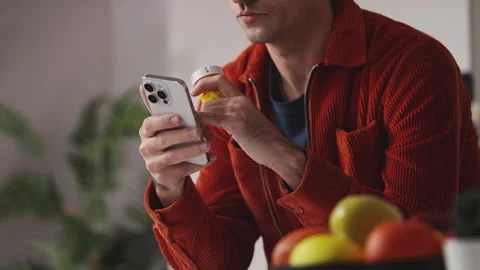 Young man reading medication side effects on cellphone, using therapy mobile app Stock Footage 341016737
