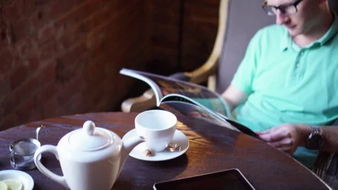 Young man reading menu sitting in cafe Stock Footage 73126525