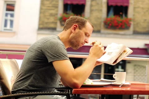 Young man reading newspaper in the restaurant  NTSC 動画素材 40342950