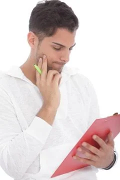 Young man reading notes on a clipboard Stock Photos