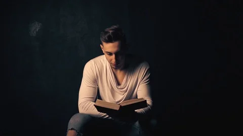 Young man reading an old book Stock Footage 100133002