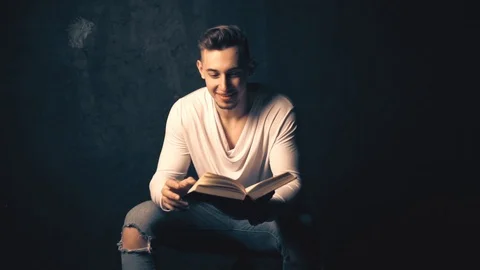 Young man reading an old book Stock Footage 100133214