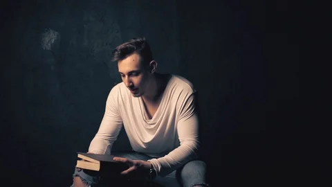 Young man reading an old book 動画素材 100133553