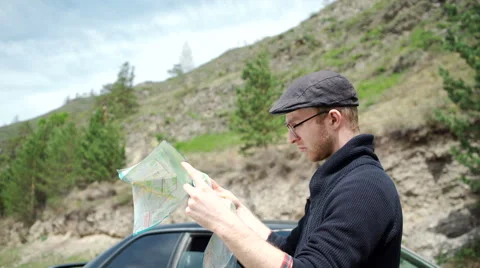 Young man reading a road map Stock Footage 63127218