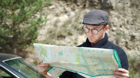 Young man reading a road map Stock Footage 63127299