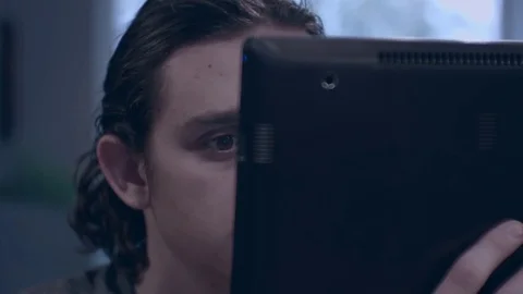 Young man reading on a tablet Stock Footage 75277644