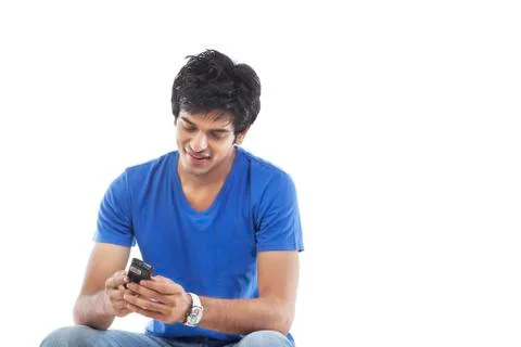Young man reading text message over white background Foto stock