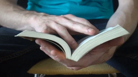 A young man reads a book Video stock 77111361