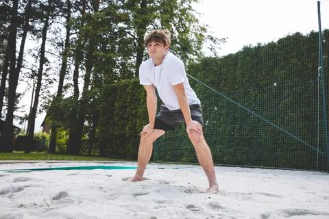 Young man in a ready position, preparing to receive or dig a volleyball on a  Foto stock
